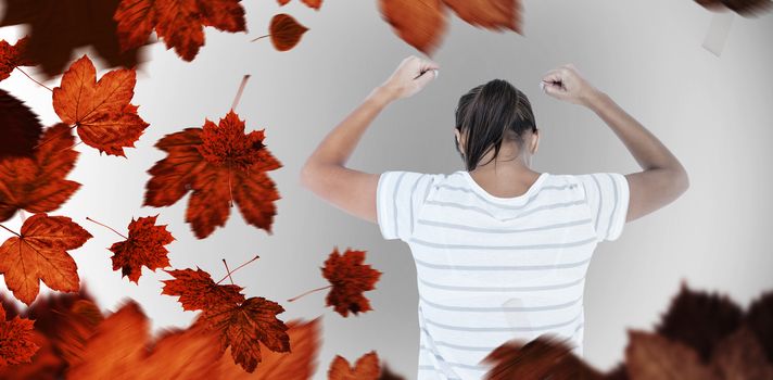 Depressed woman with hands raised against autumn leaves
