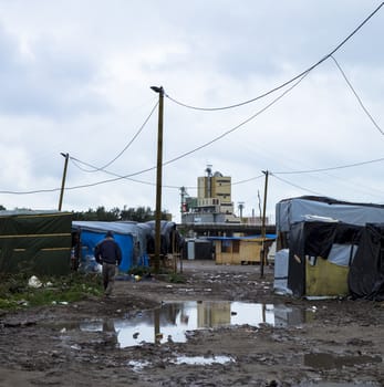 FRANCE, Calais: A man walks to morning prayers at the New Jungle refugee and migrant camp near Calais, France, on September 17, 2015.	Refugees and migrants trying to enter the UK from France are facing dropping temperatures and poor sanitation at the makeshift camp.