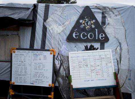 FRANCE, Calais: A school schedule is seen at the New Jungle refugee and migrant camp near Calais, France, on September 17, 2015.	Refugees and migrants trying to enter the UK from France are facing dropping temperatures and poor sanitation at the makeshift camp.