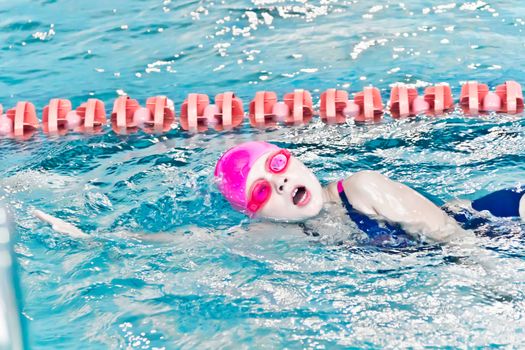 Photo of cute girl in swimming pool