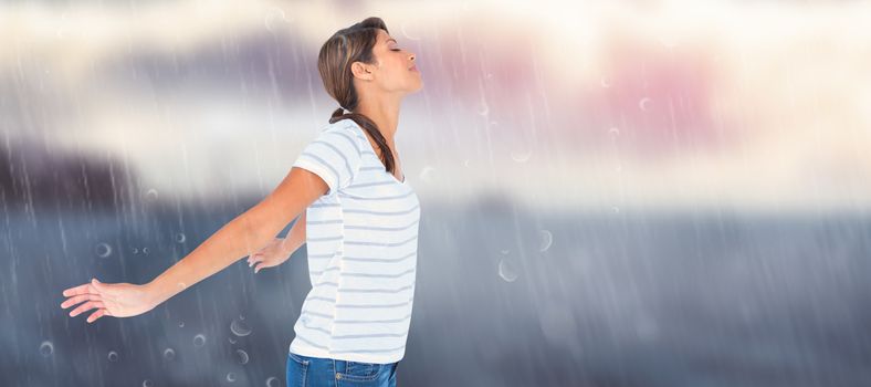 Side view of relaxed woman with arms outstretched against calm sea with lighthouse