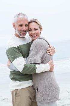 Romantic couple hugging each other at the beach