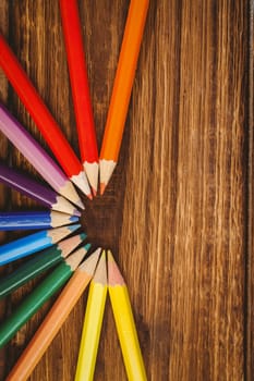 Colour pencils on desk in circle shape shot in studio