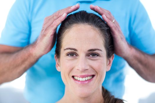 Portrait of smiling woman getting reiki treatment at home