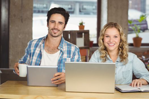 Business people posing and smiling while working at office 