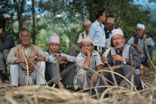 NEPAL, Patan: Nepalese men take rest during the festival of Rato Machindranath in Patan, Nepal on September 22, 2015. The festival takes place each April, but was delayed this year after a devastating earthquake damaged the chariot that devotees pull through the area in the hope of securing a good harvest.