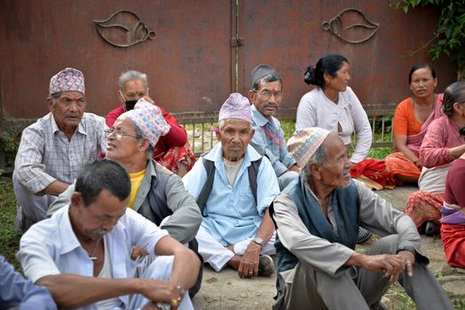 NEPAL, Patan: Nepalese men take rest as Hindu and Buddhist devotees celebrate the festival of rain god Rato Machindranath in Patan, Nepal on September 22, 2015. The festival takes place each April, but was delayed this year after a devastating earthquake damaged the chariot that devotees pull through the area in the hope of securing a good harvest.