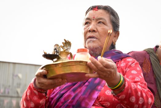 NEPAL, Patan: A Nepalese woman looks on as Hindu and Buddhist devotees celebrate the festival of rain god Rato Machindranath in Patan, Nepal on September 22, 2015. The festival takes place each April, but was delayed this year after a devastating earthquake damaged the chariot that devotees pull through the area in the hope of securing a good harvest.