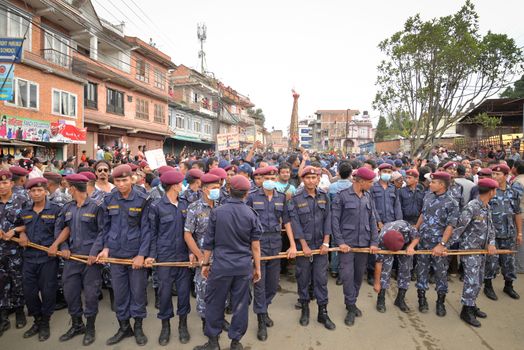 NEPAL, Patan: Soldiers stand guard as Hindu and Buddhist devotees celebrate the festival of rain god Rato Machindranath in Patan, Nepal on September 22, 2015. The festival takes place each April, but was delayed this year after a devastating earthquake damaged the chariot that devotees pull through the area in the hope of securing a good harvest.