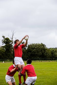 Rugby players jumping for line out at the park