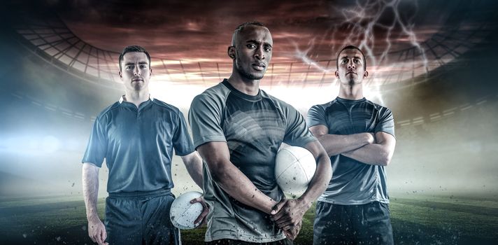 Rugby player holding a rugby ball against rugby pitch