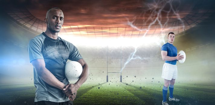 Rugby player holding rugby ball against rugby pitch