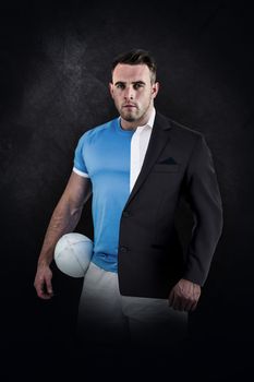 Rugby player looking at camera against half a suit