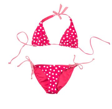 Bright pink swimsuit in white polka dots isolated on white background