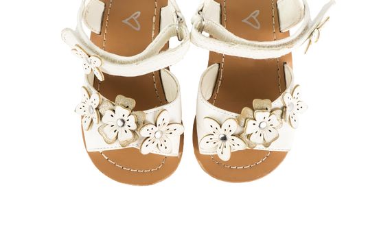 leather white baby girl summer sandals isolated on a white background, top view