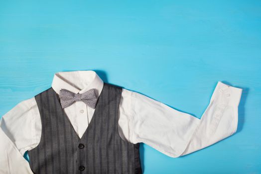 white shirt, gray vest and a bow tie on a bright blue background, the concept of the festival, celebrations, ceremonies happy Father's Day, Happy Birthday Dad