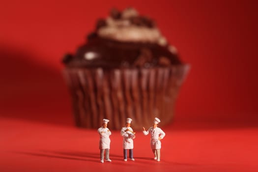 Funny Rendition of Miniature Chefs With Cupcake