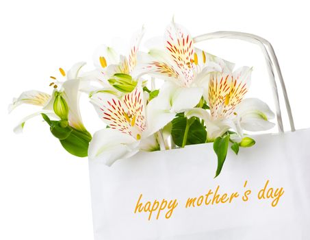 Beautiful bouquet of white  alstroemeria flowers in a paper bag with the inscription happy mother's day, greeting concept