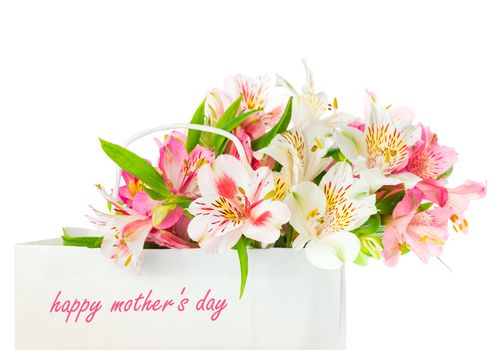 Beautiful bouquet of white and pink alstroemeria flowers in a paper bag with the inscription happy mother's day, greeting concept