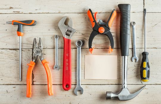 Greeting Card, Happy Father's Day, Birthday Dad, concept, set of different carpentry tools: a hammer, Hand saw, pliers, wrench, screwdriver, various spanners, clamp on a wooden background and tablet