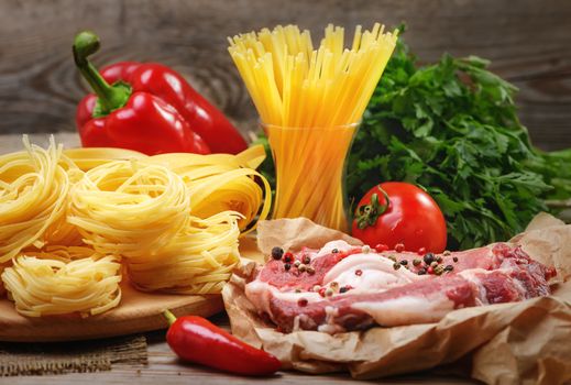 Ingredients for cooking pasta, Italian food, meat and spices, tomato, bell pepper