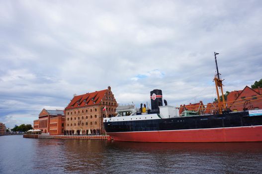 GDANSK, POLAND - JULY 29, 2015: Industrial ship on the Motlawa river by buildings