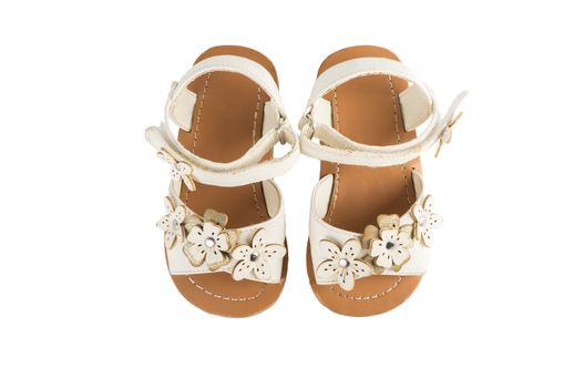 leather white baby girl summer sandals isolated on a white background, top view