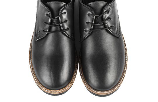 Male classic black leather stylish shoes with laces close up, top view