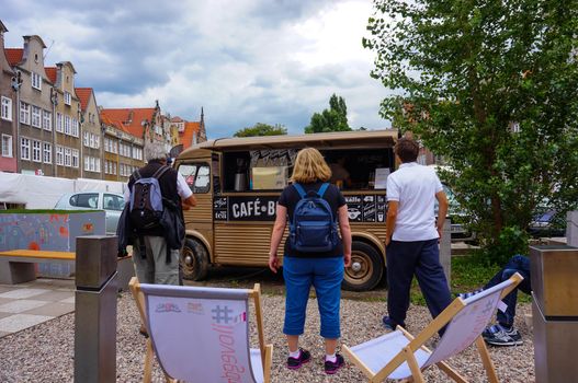 GDANSK, POLAND - JULY 29, 2015: People standing in front of a coffee bus in the city center