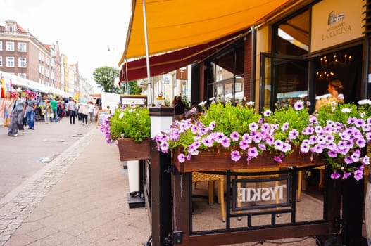 GDANSK, POLAND - JULY 29, 2015: Pink flowers at a restaurant entrance