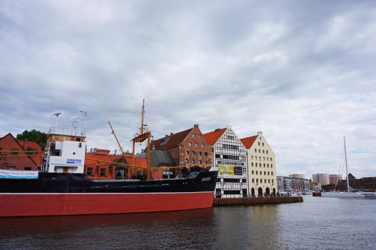 GDANSK, POLAND - JULY 29, 2015: Industrial ship on the Motlawa river by buildings