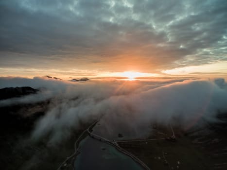 Aerial view of midnight sun above clouds on Lofoten islands in Norway