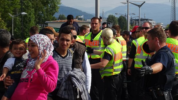 AUSTRIA, Salzburg: Scores line up at the border control in Salzburg, Austria on September 22, 2015 amid an ongoing refugee crisis, which has seen thousands flee from Syria and other war-torn countries for safety in Europe.