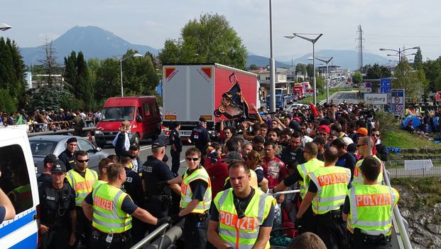 AUSTRIA, Salzburg: Scores line up at the border control in Salzburg, Austria on September 22, 2015 amid an ongoing refugee crisis, which has seen thousands flee from Syria and other war-torn countries for safety in Europe.