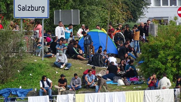 AUSTRIA, Salzburg: Scores line up at the border control in Salzburg, Austria on September 22, 2015 amid an ongoing refugee crisis, which has seen thousands flee from Syria and other war-torn countries for safety in Europe.