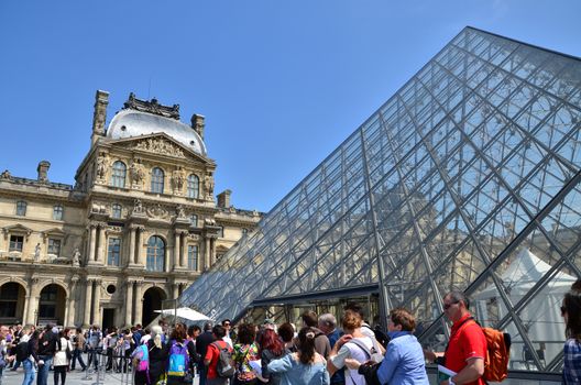 Paris, France - May 13, 2015: Tourist visit Louvre museum on May 13, 2015 in Paris. This is one of the most popular tourist destinations in France.