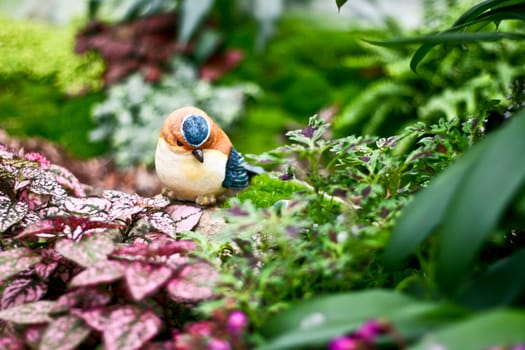 Bird statue with garden background