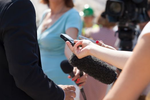 Journalists making interview with businessperson or politician