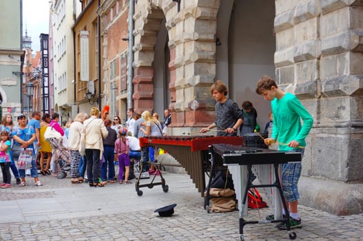 GDANSK, POLAND - JULY 29, 2015: Two young men playing instruments at the city center