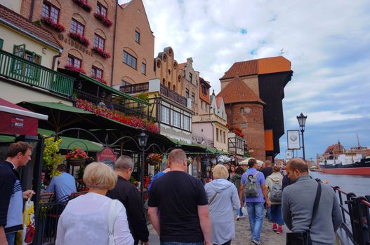GDANSK, POLAND - JULY 29, 2015: Many people walking on a street next to the Motlawa river in the city center