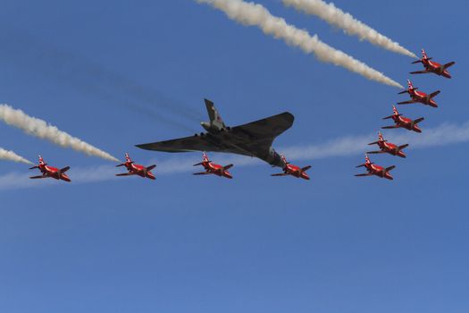 ENGLAND, Southport: The Red Arrows take their final formation flight with a Vulcan bomber during the Southport Airshow 2015 in Southport, Merseyside in England on September 19, 2015