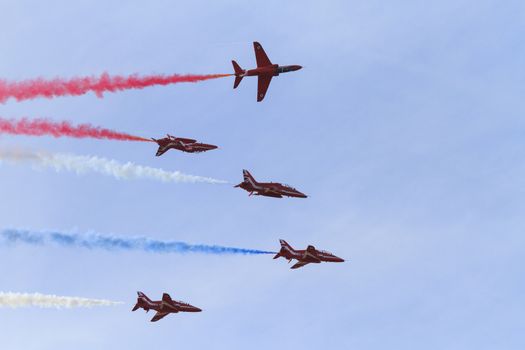 ENGLAND, Southport: Red Arrows fly in formation spewing coloured smoke during the Southport Airshow 2015 in Southport, Merseyside in England on September 19, 2015