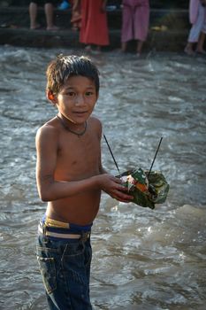 NEPAL, Nuwakot: Santosh Shrestha, a 10 year-old boy from Okharpauwa, Nuwakot District performs a religious ritual at Bagamti River Bank during Father's Day, on September 13, 2015.	Santosh's father passed away when he was six months old, and this was his fifth time performing the religious ritual at Gokarna, along with his grandfather, grandmother and his mother. He lives in poverty on a rubbish dump with his family, and is not able to go to school. 