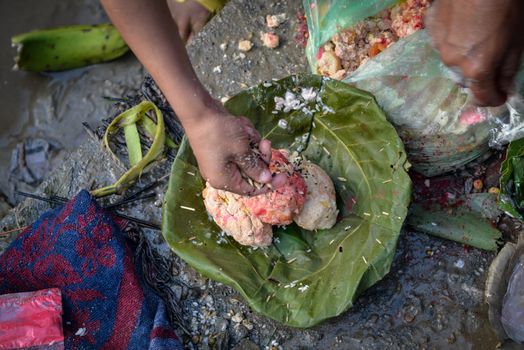 NEPAL, Nuwakot: Santosh Shrestha, a 10 year-old boy from Okharpauwa, Nuwakot District performs a religious ritual at Bagamti River Bank during Father's Day, on September 13, 2015.	Santosh's father passed away when he was six months old, and this was his fifth time performing the religious ritual at Gokarna, along with his grandfather, grandmother and his mother. He lives in poverty on a rubbish dump with his family, and is not able to go to school. 