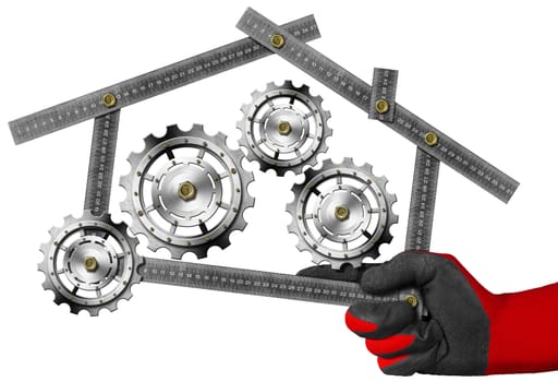 Hand with work glove holding a metal meter ruler in the shape of house with gears, symbol of house industry. Isolated on a white background
