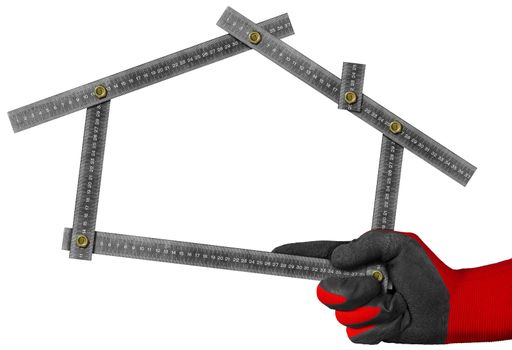 Hand with red and black work glove holding a metal meter ruler in the shape of house isolated on white background. Concept of house project 
