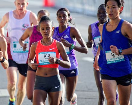 AUSTRALIA, Sydney: Ethiopian Worknesh Degefa (front left) runs in the Sydney Marathon held during the Sydney Running Festival on September 20, 2015. Around 30,000 participants took part in the 15th Sydney Running Festival which incorporates a 42km marathon, a half marathon, a 9km bridge run as well as a 3.5km family fun run