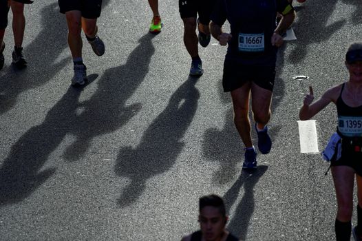 AUSTRALIA, Sydney: Participants cast shadows during the Sydney Running Festival on September 20, 2015. Around 30,000 participants took part in the 15th Sydney Running Festival which incorporates a 42km marathon, a half marathon, a 9km bridge run as well as a 3.5km family fun run