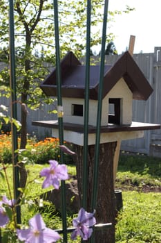 House for the birds painted in gray with brown