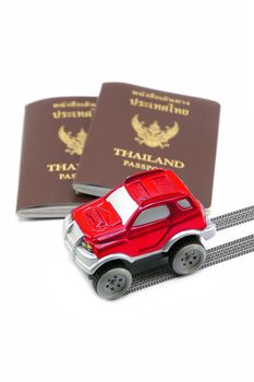 Thailand passport and red 4wd car for travel concept.